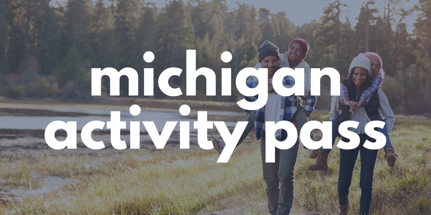 family hiking on a trail with "Michigan Activity Pass" written over the image