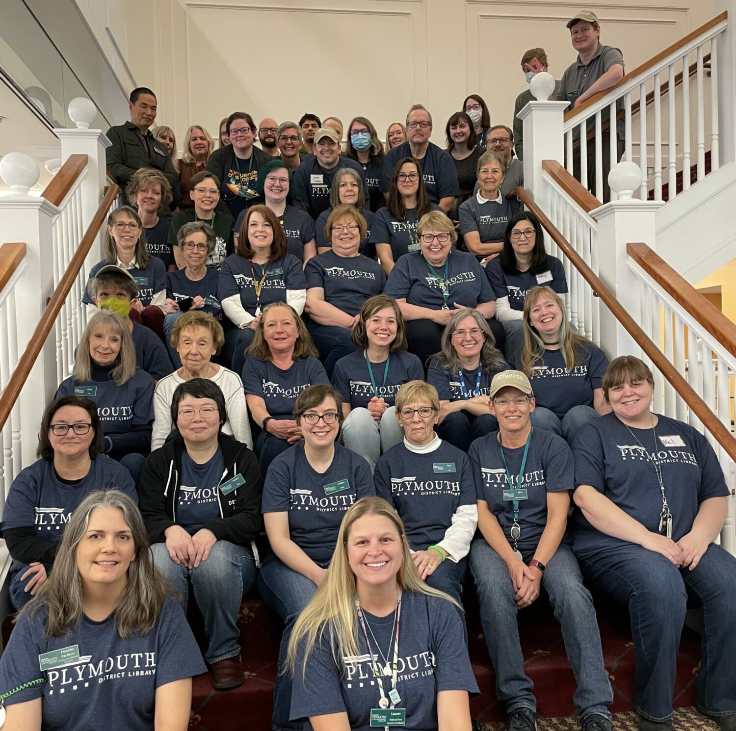 large group of smiling library employees