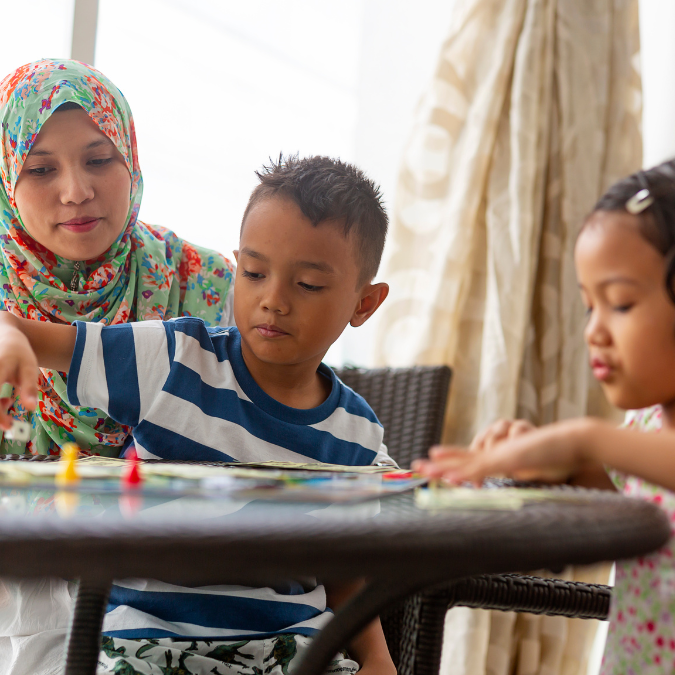 family plays board game together