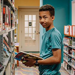 teen checks out the library's graphic novels
