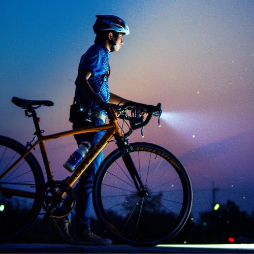 person bikes with bike light as night falls