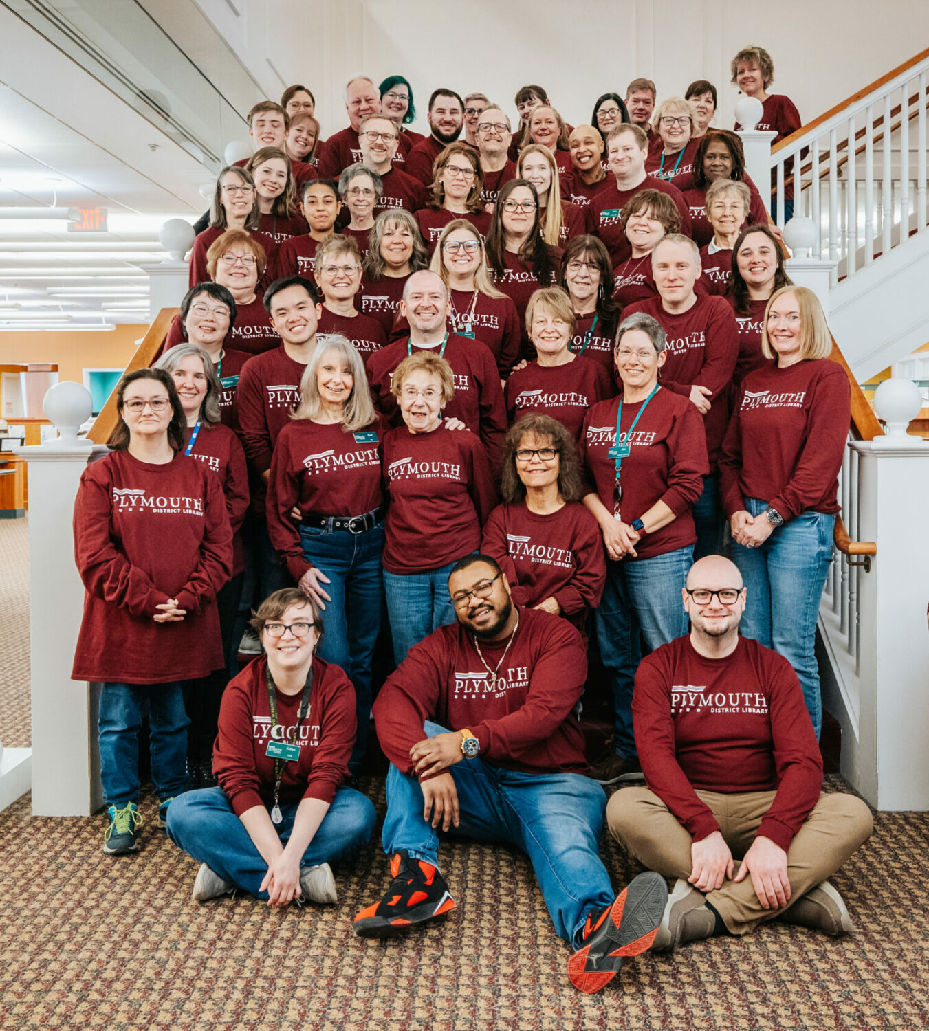 large group of smiling library employees
