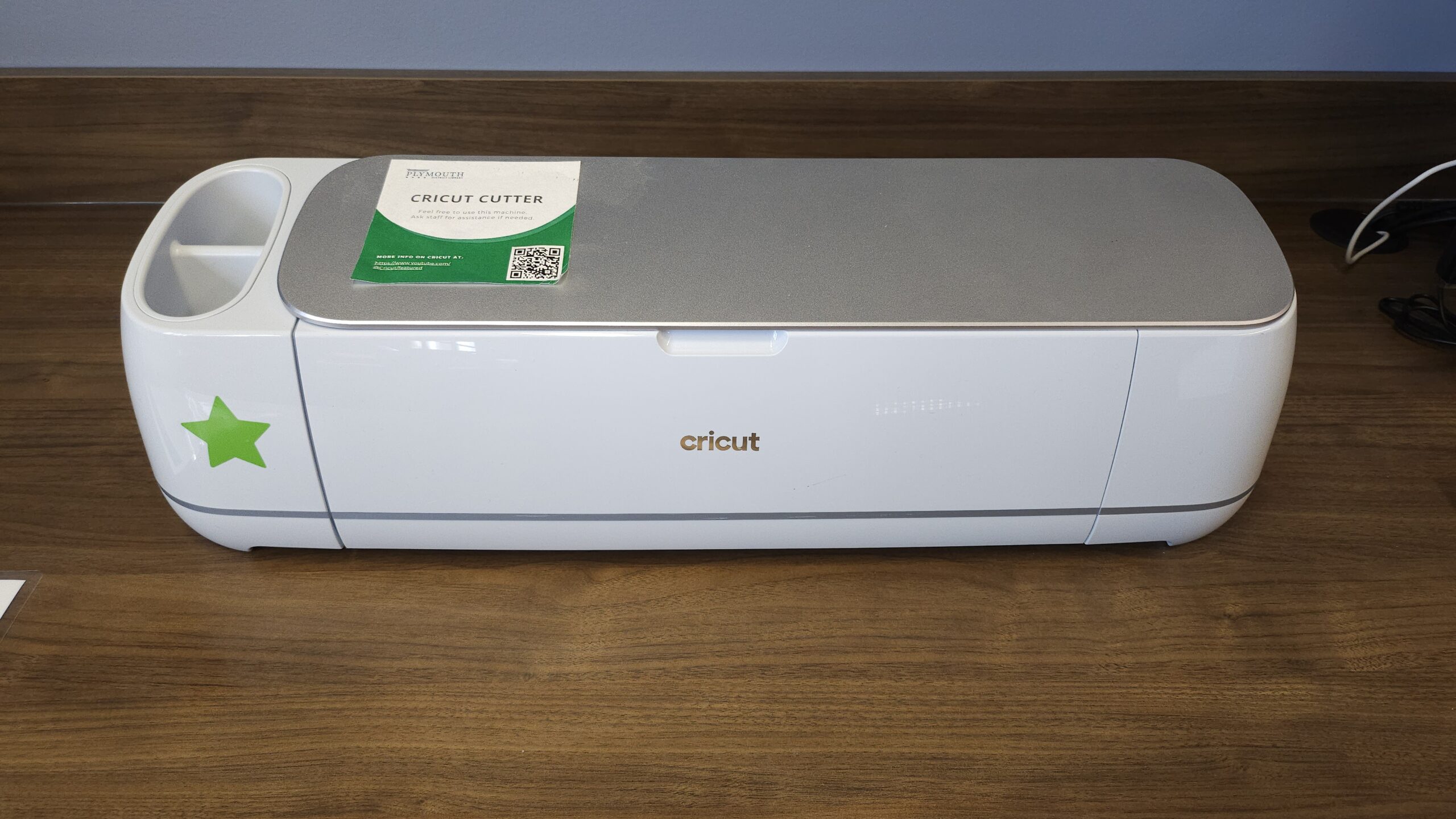 Cricut Machine on a wooden desktop