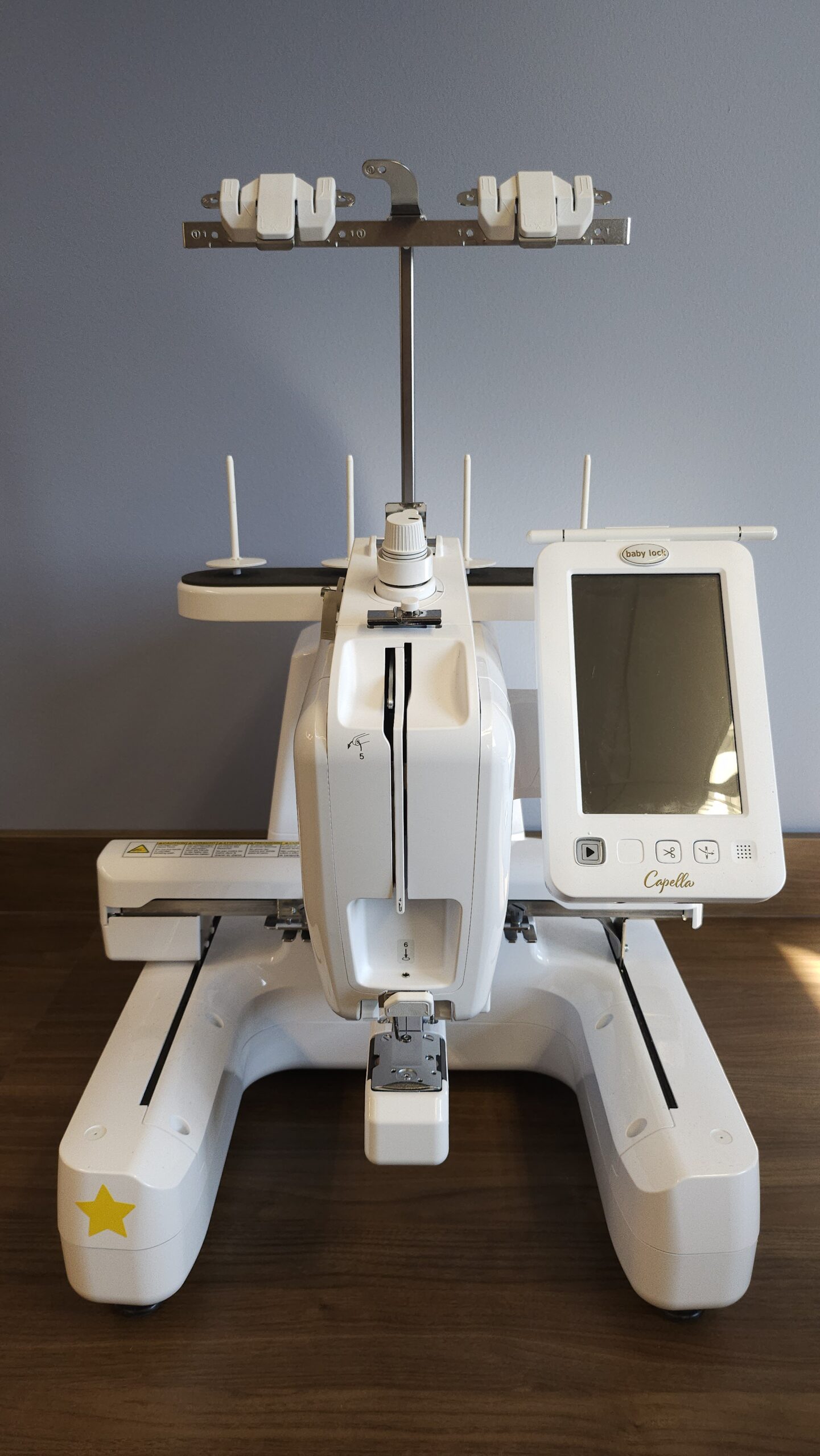 Embroidery machine on  a wooden desktop