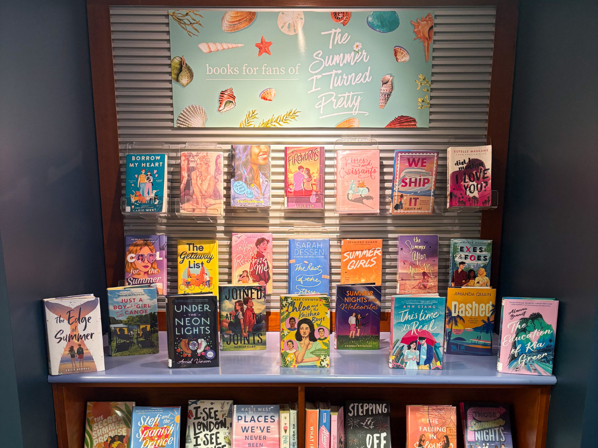 Display of books with the banner "Books for Fans of The Summer I Turned Pretty". Titles include teen romance authors and books with bright blue, orange, and pink covers.