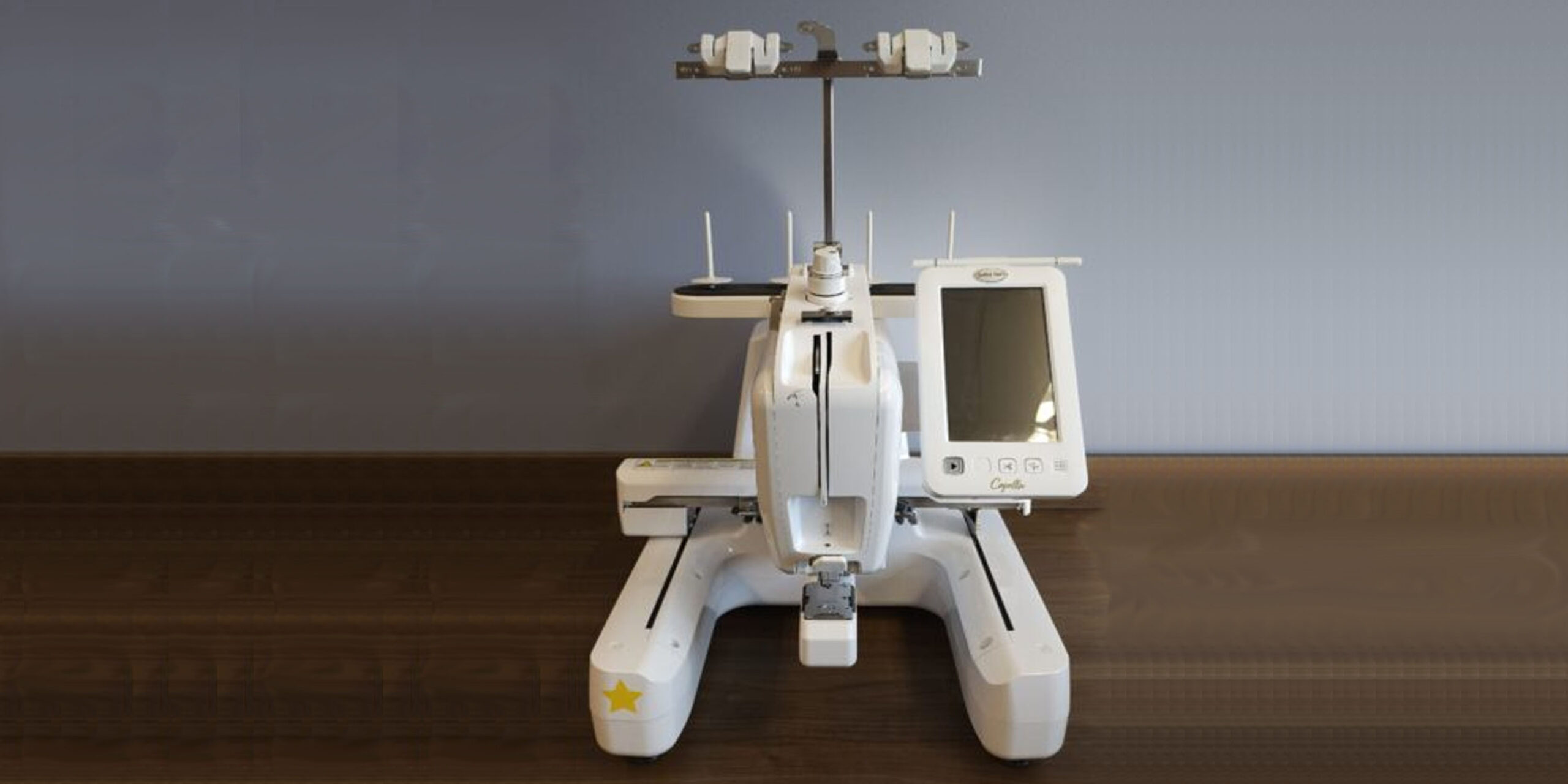 Embroidery machine on a wooden desktop