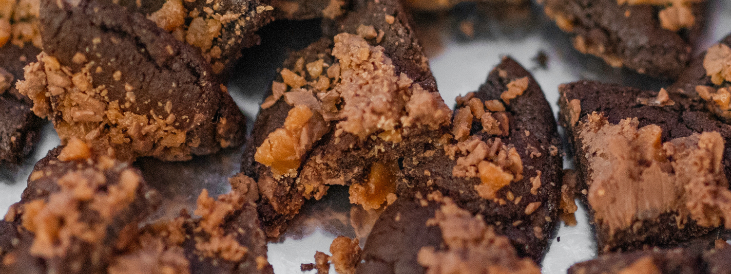 A chocolate and toffee cookie, cut up into fours.
