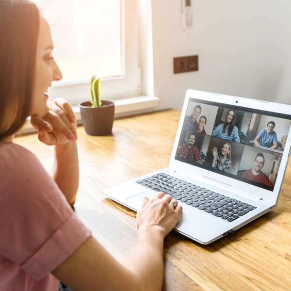 woman looks at a laptop computer that shows her on a video call