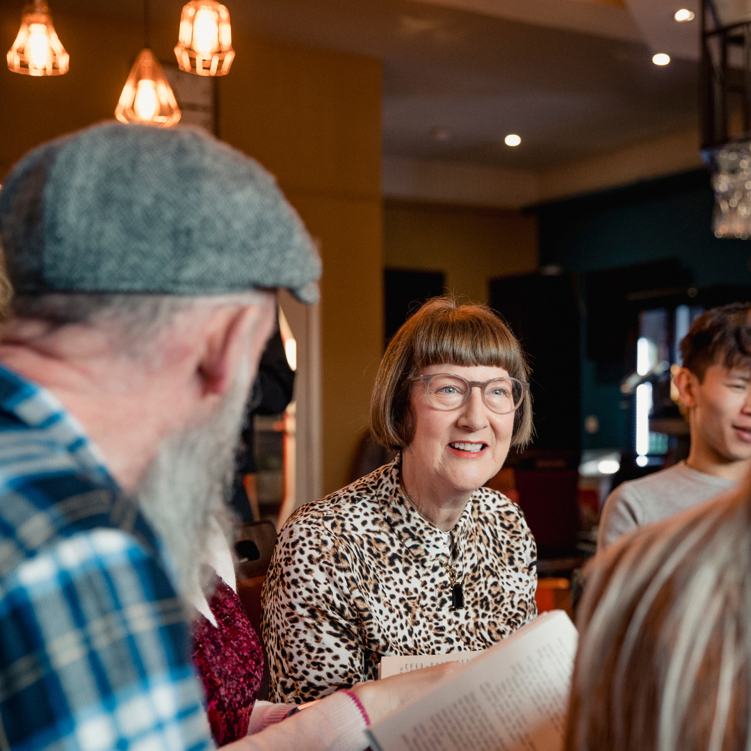 woman looking at a group of friends in a restaurant